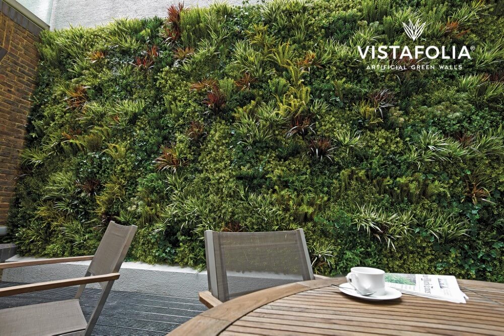 Alternate angle of cafe sitting area with artifcial living wall