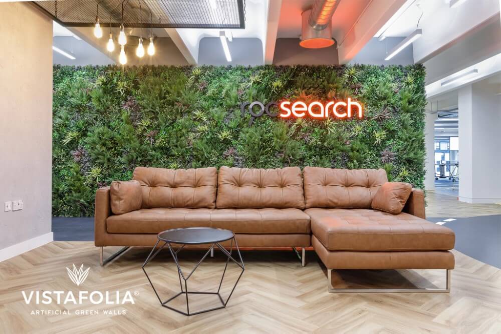 Couch in front of artificial living wall installed by Greenerwalls