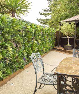 Residiential patio accented with an artificial plant wall